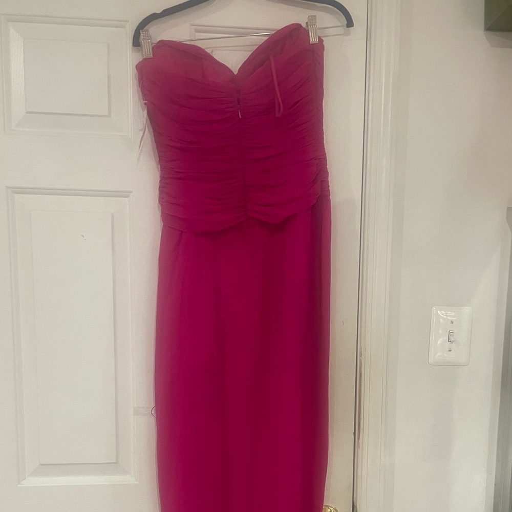 100% pink strapless evening gown with diamond cut out in the front. Prom perfect